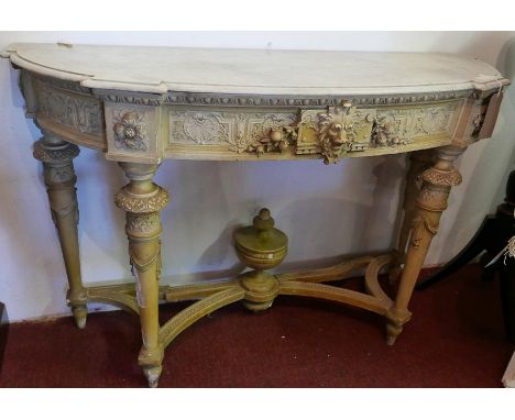 An early 20th century cream painted Neoclassical style marble top console table, carved and pierced frieze with lion head and