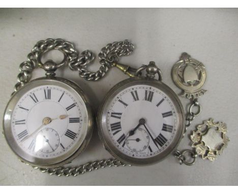 A silver cased pocket watch with engine turned case, and another similar, along with a silver watch chain 