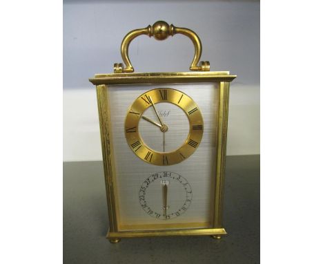 An Imhof Swiss 15 jewel brass carriage clock, silvered face with gold coloured chapter ring, having Roman numerals, with date