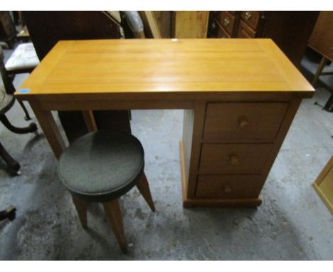 A contemporary light wood dressing table on pedestal with three drawers to one side and square legs, united by a single stret