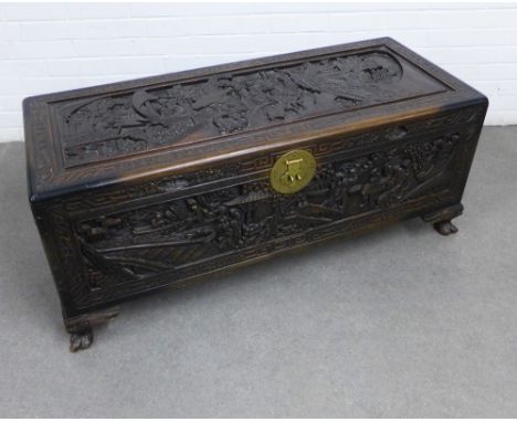 Chinese camphorwood trunk / blanket box, profusely carved with figures and a Greek Key border, with stylised brass clasp, hin