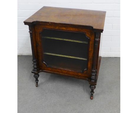 Late 19th century walnut music cabinet, with two interior shelves, a glazed door, ceramic casters and pilasters. 61 x 68 x 41