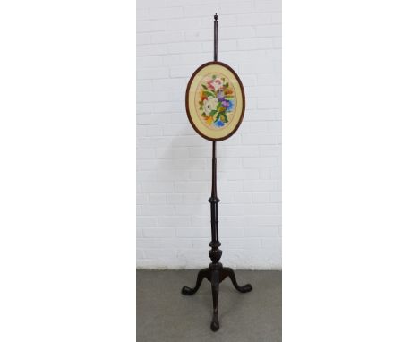 19th century pole screen with a floral embroidered panel, carved tripod legs and pad feet, 151cm tall.