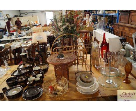 An Eastern carved table together with a bamboo magazine rack, wine rack, artificial flowers, three Poole Pottery dishes etc.