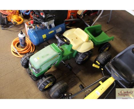 A child's pedal John Deere tractor and trailer