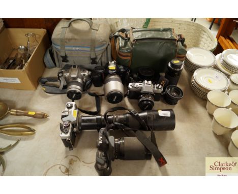 A quantity of various cameras to include; Nikon F50, Minolta X-300 together with lenses and cases