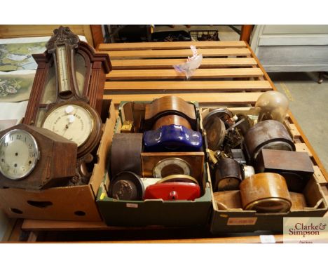 Three boxes containing various clocks and clock parts