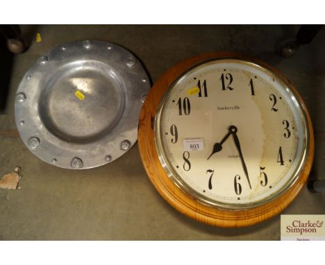 A Baskerville wall clock together with a pewter tray