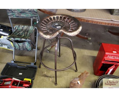 A cast iron adjustable tractor seat stool (96)