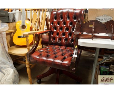 A reproduction button down upholstered swivel office chair