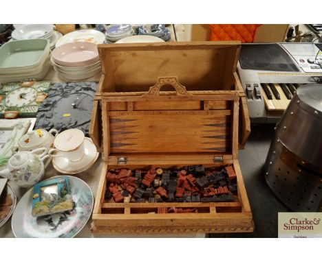 A carved wooden games compendium including backgammon and chess