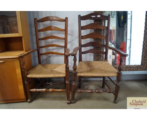 Two oak ladder back elbow chairs