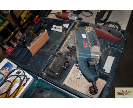 A Bosch professional belt sander and a small Black &amp; Decker orbital sander