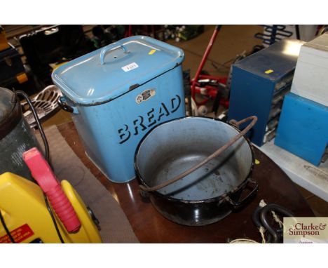A blue enamel bread bin and a large metal preserving pan