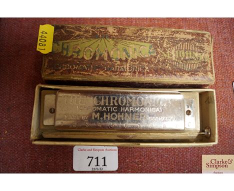 An M Hohner chromatic harmonica