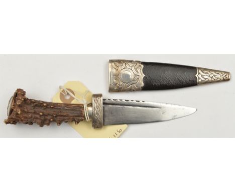 A skean dhu, SE blade 3½” (repointed) with short scalloped back edge and fuller, staghorn grip, livery button pommel, silver 