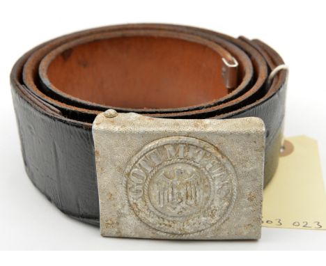 A Third Reich aluminium Army belt buckle, of 2 piece construction with no maker’s marks, on a black patent leather belt. GC (
