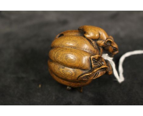 A modern Japanese netsuke carved as two mice and a pumpkin, 4.5cm high