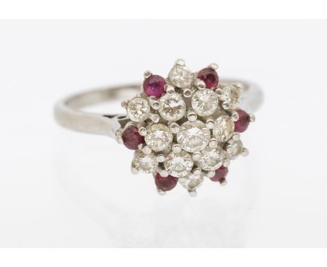 18ct White Gold Diamond & Ruby Cluster Ring. The ring is hallmarked "18" for 18ct Gold.  The Ring contains thirteen Round Bri