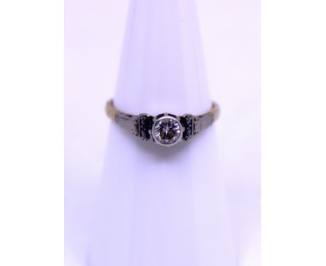 Unmarked Yellow and White Metal approx. 0.20ct Solitaire Round Brilliant Cut Diamond Ring. The 0.20ct Round Brilliant Cut Dia