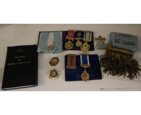 Four silver gilt Masonic medals, four others a "Ye Exe Valley Lodge" sash, a Masonic rule book and manual of instruction