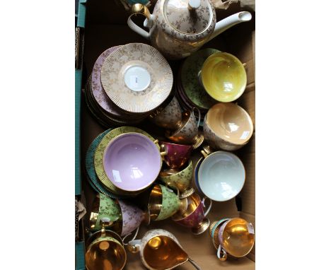 A 1950's/60's harlequin pattern coffee service comprising twelve cups and saucers, sandwich plates, serving plate, coffee pla