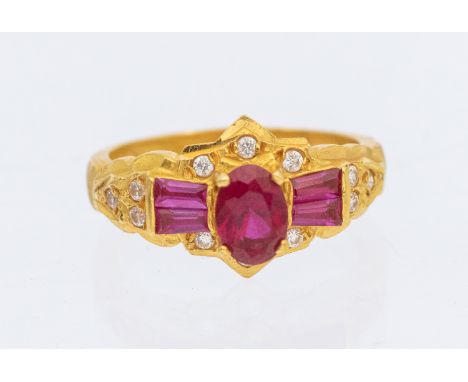 Unmarked Yellow Metal Synthetic Ruby and Cubic Zirconia Dress Ring.  The ring contains an Oval Brilliant Cut Synthetic Ruby i