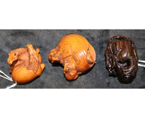 Three modern Japanese carved wood netsuke modelled as three rats and a nut, signed, 4.5cm wide, a netsuke of two foals, signe