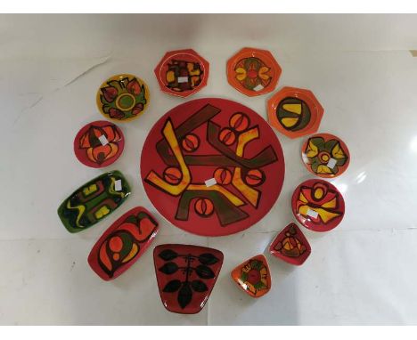A large Poole pottery 'Delphis' charger approximately 35cm in diameter, together with 12 other smaller various shaped Poole p