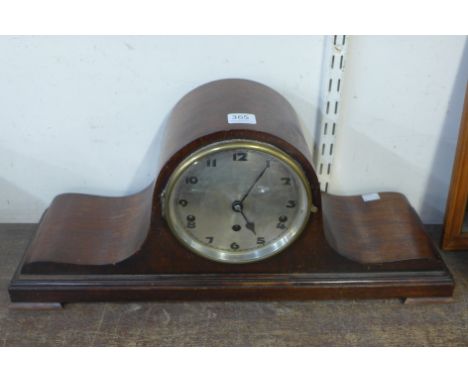 A mahogany mantel clock, mahogany barometer and an oak barometer