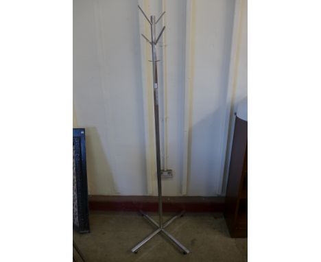 A chrome ceiling light and coat stand