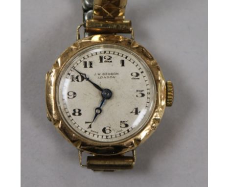 A lady's 9ct gold J.W. Benson manual wind wrist watch on a gold plated flexible bracelet.