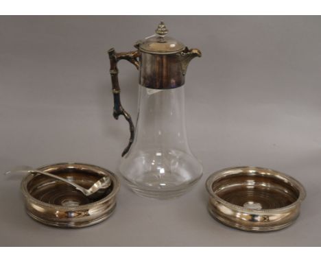 A silver plate mounted claret jug, a pair of silver plated wine coasters and a plated sauce ladle.