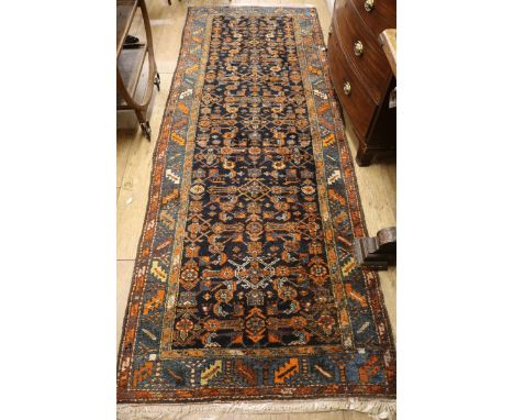 A Caucasian black ground hall carpet 294 x 105cm