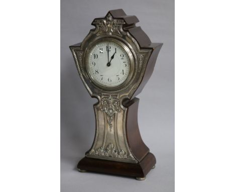 An early 20th century silver mounted mantel timepiece, Birmingham 1909, the shaped wooden case with applied silver panel to f