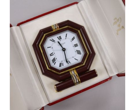 A Must de Cartier gilt metal and lacquer cased travelling quartz alarm clock, in fitted Must de Cartier case.