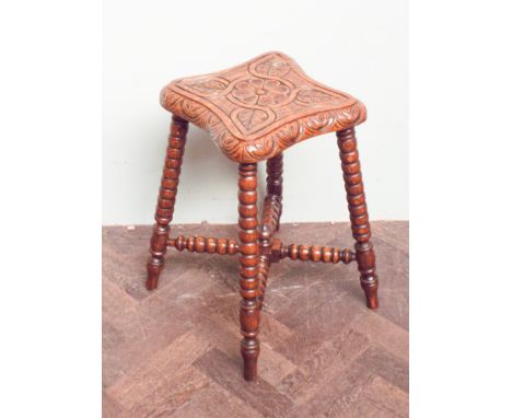Carved oak stool on bobbin turned legs with cross stretchers 