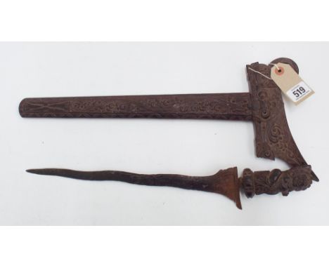 Malayan dagger, slightly curved watered steel blade - measuring 12" long in its highly carved scabbard and handle in the form