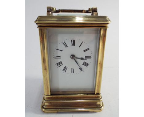 French gilt brass carriage clock - measures 16cm tall to top of handle