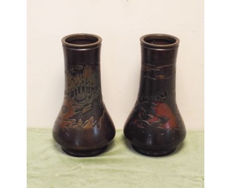 A pair of 12" Japanese bronze vases, one is decorated with birds in the sunrise and the other is decorated with a hunting sce