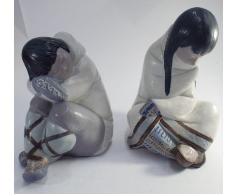 Large pair of Lladro seated models of Eskimo girls - measuring 30cm tall  The larger model is hairlined