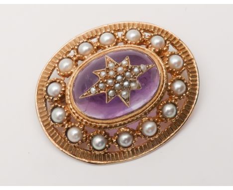 Antique style amethyst and pearl oval brooch set with cabochon amethyst with seed pearl star fish shaped detail with golden p