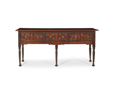 QUEEN ANNE OAK DRESSER BASE EARLY 18TH CENTURY the rectangular top over three moulded panel short frieze drawers with lion ma