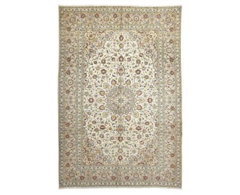 KASHAN CARPET CENTRAL PERSIA, LATE 20TH CENTURY the ivory field with grey and light blue medallion, grey spandrels, within gr