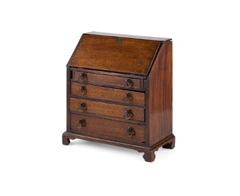 MINIATURE OAK BUREAU 19TH CENTURY the fall flap enclosing a fitted interior, over four long graduated drawers, on bracket fee