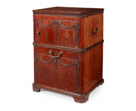 GEORGE III MAHOGANY NIGHT COMMODE 18TH CENTURY the hinged crossbanded top above a door with carved swags, over a drawer and a