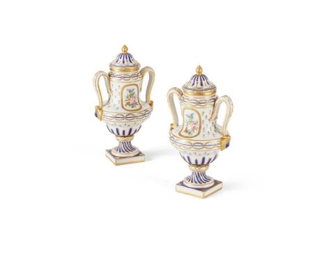 PAIR OF SÈVRES STYLE URNS AND COVERS LATE 19TH/ EARLY 20TH CENTURY of twin handled form, raised on a socle base and square se