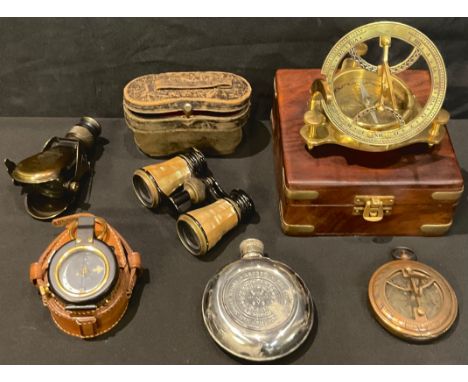 A reproduction brass sundial compass, brass bound box with hinged cover; a brass reproduction ship's compass, brown leather c