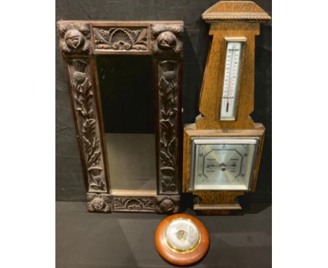 A 19th century Scottish carved oak rectangular mirror, 60cm x 30cm; a Art Deco oak barometer; another (3) 