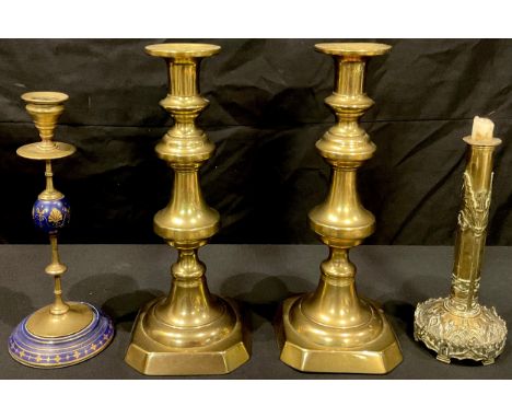 A pair of large Victorian brass ejector candlesticks; a French brass and porcelain candlestick; a Victorian brass Gothic cand
